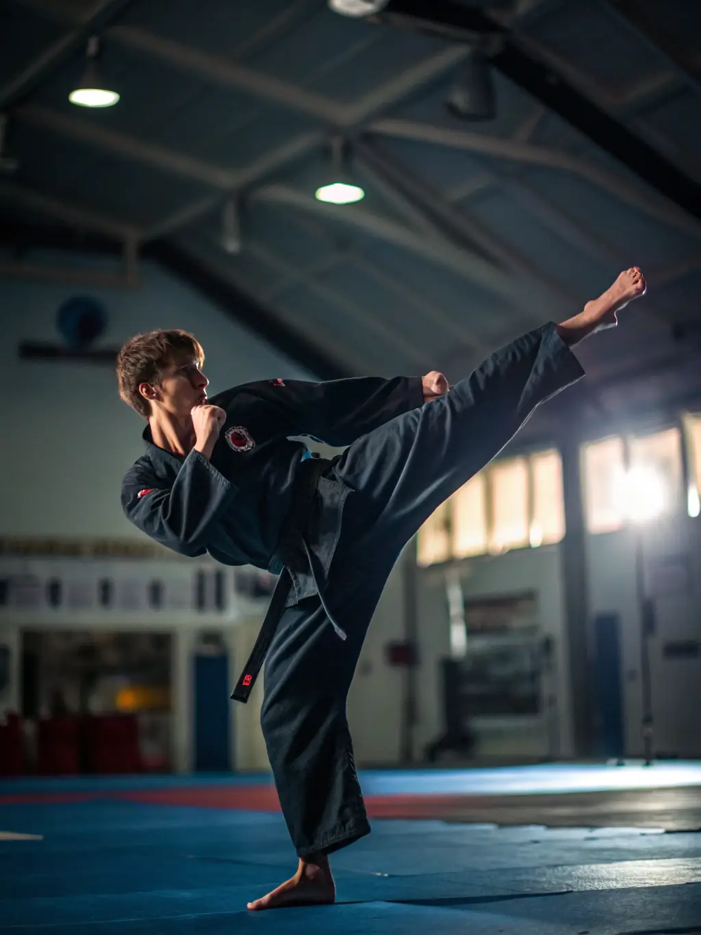 A teenager performing a complex karate move during an advanced training session at KCSSA.